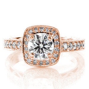 This design is intricately detailed with hand engraved patterns and filigree on the band. The halo and top of the band both have micro pavé diamonds while all edges of the ring are textured with milgrain for a refined finish. All of this exquisite detail showcases the round brilliant center diamond.