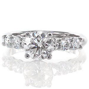 Starling is a delightful setting that shimmers with diamonds. The 1.0 carat round brilliant diamond flashes with sparkle for a radiant sight. A row of three diamonds flank each side of the ring to embellish the beautiful band. The height of the center stone sits tall to allow for a matching diamond band. 