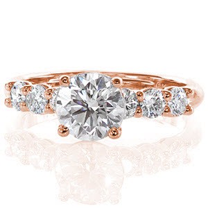 Starling is a delightful setting that shimmers with diamonds. The 1.0 carat round brilliant diamond flashes with sparkle for a radiant sight. A row of three diamonds flank each side of the ring to embellish the beautiful band. The height of the center stone sits tall to allow for a matching diamond band. 