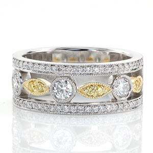 Unique custom wide band ring in Charlotte with bead set diamond rails bordering a two tone design.
