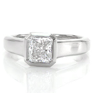 Cashmere is a luxurious design featuring a 1.0 carat radiant cut diamond. The mirrored bezel securely and precisely borders the dramatic octagonal lines of the stone. The wide band tapers to the bottom, giving importance to the brilliant center. Triangular open pockets add dimension and character to the side of the band.   