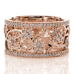 The beautiful hand crafted, floral band is inspired by the stunning flowering cherry trees. The edges of each branch are detailed in milgrain texture for dimension. There are two rows of micro pavé framing the design, and each flower and leaf is adorned with vibrant diamonds.