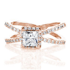 Galaxy is a unique design inspired by the night sky. The criss-crossing bands and raised halo are all adorned with micro pavé that will twinkle like the stars. The 0.75 carat princess cut diamond is the center of attention with chevron prongs holding the corners securely in place.