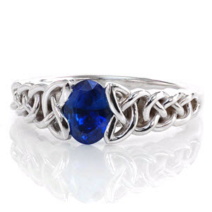 The Tiffany design mimics the ascent of Ireland's highlands. Bands of 14k white gold connect to create a traditional Celtic Knot that graduates in scale. Reaching the pinnacle, a natural oval cut blue sapphire is connected to its setting by two larger knots that form a half bezel.