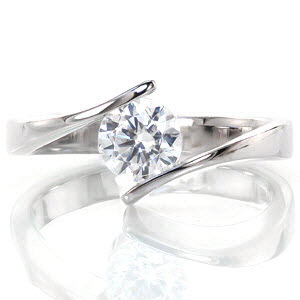 Breeze is a delightful modern solitaire featuring a 0.75 carat center stone. The bypass securely fashions the round diamond at the top of the band for a contemporary feel. The sleek high-polished finish enhances the brilliance of the diamond. This low-profile setting sits closely to the finger for comfort and style.
