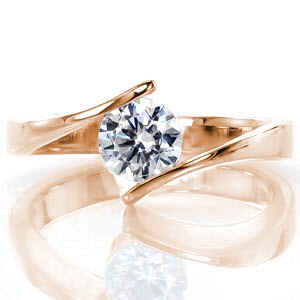 Breeze is a delightful modern solitaire featuring a 0.75 carat center stone. The bypass securely fashions the round diamond at the top of the band for a contemporary feel. The sleek high-polished finish enhances the brilliance of the diamond. This low-profile setting sits closely to the finger for comfort and style.