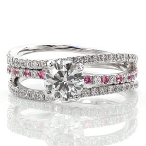 Starfish has a serene wave of three micro pavé diamond bands. As the center band is accented with round cut pink sapphires, a stunning 1.00 carat round brilliant cut diamond is set to accent the graceful flow of the ring. The three bands are joined as one at the bottom and crafted in 14k white gold.