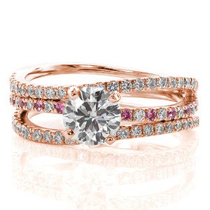 Starfish has a serene wave of three micro pavé diamond bands. As the center band is accented with round cut pink sapphires, a stunning 1.00 carat round brilliant cut diamond is set to accent the graceful flow of the ring. The three bands are joined as one at the bottom and crafted in 14k white gold.