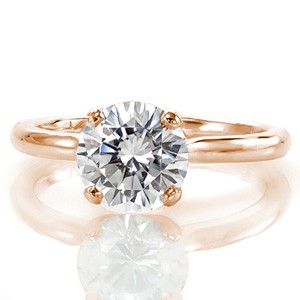 The graceful cathedral style Lace solitaire features swooping shoulders that beautifully lead the eye upwards toward the center stone. The 1.50 carat round brilliant center stone is held in place by a four prong crown. The prongs taper into a decorative double prong for a unique touch. 