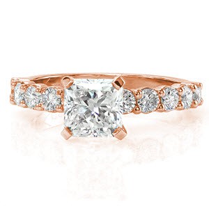 Kelsey Marie is a classic beauty with round brilliant cut diamonds in prong settings adorning the band. The center stone is a 1.50 carat radiant cut in an elevated setting. Vibrant stones dazzle with a prism of colors in any light. The 14k white gold metal reflects the same brightness as each of the diamonds.