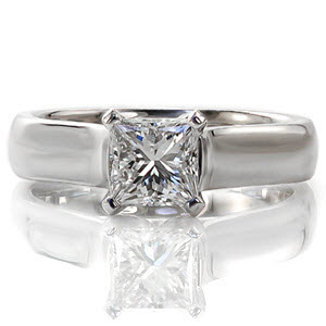 Mastering a modern sophisticated style, the Newell design engagement ring features a 1.00 carat princess cut center diamond. A 14k white gold high polished cathedral setting contours upwards towards the center stone. Stately V-shaped prongs protect the stones corners and contribute to its contemporary appeal.