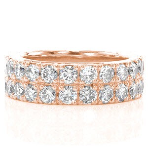 Two rows of round cut diamonds create a brilliant sea of diamonds in Design 2084. Each of the diamonds are set by four prongs within a band of 14k white gold. The curled waves of hand formed filigree and a hand engraved half wheat pattern adorn both ring faces.