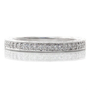 The Valencia band is an heirloom that can be worn alone with grace or next to the matching engagement ring for a completed look. Crafted in 14k white gold, one row of  micro pavé diamonds are finished with a frame of miligrain. Hand engraving and milgrained filigree add to the vintage design.