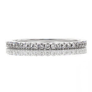 A petite version of our original Fascination Band, the Fascination Petite band has a total of 0.39 carats of round cut diamonds. The stones are prong set within a band of 14k white gold. Both ring faces display a fine detailed line between each prong.