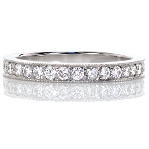 Pave incorporates the classic round brilliant shape along the length of the band for a timeless statement. The white gold metal enhances the sparkle of the round diamonds for a radiant sight. Bright cuts are made along the edge of the band then textured with milgrain for added brilliance.  