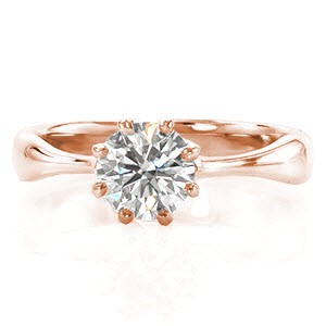 This elegant solitaire features a tapered band leading into a 0.70 carat round brilliant cut center stone. The antique inspired, eight-prong setting accentuates the round shape of the stone. The classic appeal of this ring is completed with the high polished metal of the band. 