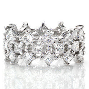 A fantastic arrangement of prong set princess cut diamonds create a unique look for Design 2141. Crafted in 14k white gold, the traditional set princess cut diamonds are highlighted by two rows of alternating kite set diamonds. The purposeful open areas between the stones add to the lattice arrangement.