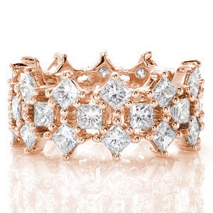 A fantastic arrangement of prong set princess cut diamonds create a unique look for Design 2141. Crafted in 14k white gold, the traditional set princess cut diamonds are highlighted by two rows of alternating kite set diamonds. The purposeful open areas between the stones add to the lattice arrangement.