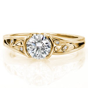 Filigree engagement ring in Allentown with half bezel center stone and yellow gold setting.