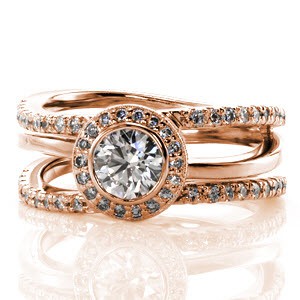 Unique in every way, Design 2165 combines a low profile with a brilliant center focal point. Crafted in 14k white gold, two micro pavé diamond bands outline a third high polished band. Nestled within the bands is a 0.75 carat round diamond that is surrounded by a micro pavé diamond halo and milgrain detail.