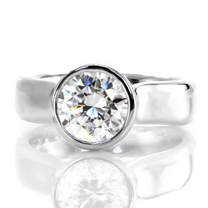 Twilight is a sophisticated engagement ring. The thick contemporary bezel contours the round outline of the 2.0 carat center stone. Set far above the mounting, the heightened cathedral displays the acclaimed profile of a round brilliant. The polished 14k white gold glistens from every angle.      