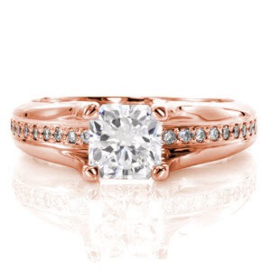 Our Radiant River is an intriguing design where micro pavé diamonds seamlessly flow beneath the center .80 carat radiant cut diamond. The four prongs of the center diamond stretch upward from the band, proudly displaying the perfectly set center stone.