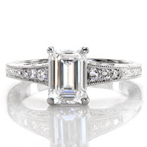 Vancouver custom antique inspired engagement ring with an emerald cut center diamond and a bead set diamond and hand engraved band.