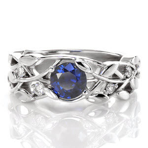This sapphire engagement ring is a beautiful low-profile setting that rests closely to the finger. The nature-inspired design resembles a delightful leaf and vine pattern for an organic feel. A vivid 0.70 carat blue sapphire is intertwined and securely fashioned between petal-shaped prongs.  