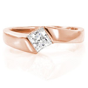 With a gentle twist, the Sway design seamlessly captures the 0.75 carat princess cut center diamond. The architectural half bezel setting adds movement to the top of the ring. A contemporary statement is made with the high polished contour of the the 14k white gold band.
