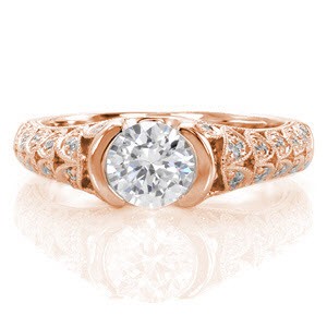 The pierced pattern is exquisitely hand-finished with micro pavé diamonds and milgrain detail. A half-bezel secures a 0.75 carat round brilliant diamond for a dramatic appeal. The side view openly displays the distinctive profile of the diamond for a magnificent perspective.    