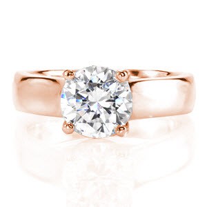 The Trellis Design is a classic statement with a 2.00 carat round brilliant cut center diamond. The high polish of the 14k white gold band accents the center stone for a luminous look. The four prongs gracefully overlap one another to create an intricate woven pattern on the sides.