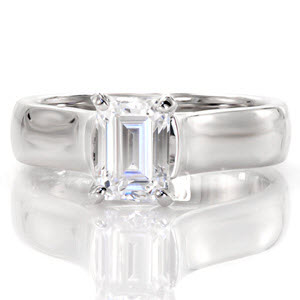 The 1.0 carat emerald cut is displayed high above the mounting for a dramatic statement. Long parallel facets gives the affect that the diamond goes on forever. The contoured swoop of the cathedral band places emphasis on the center stone. The luster of the white gold metal enhances the brilliance of the emerald.     