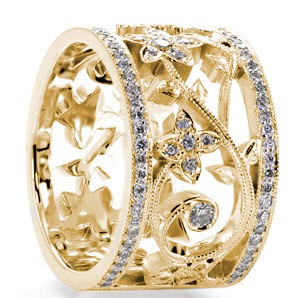 Unique custom wide band ring in Fresno with bead set diamond rails surrounding a diamond set floral designed center.