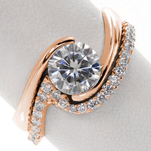 The Ripple Diamond Band is uniquely shaped to sit flush with our Ripple Engagement Ring. This design features diamonds that graduate in size to emphasize the motion of the piece. This shadow band is designed to precisely match the curve and shape of the original ring.