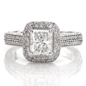 This dazzling ring is detailed with micro pavé and will mesmerize from every angle. The 1.00 carat radiant center diamond is set onto a domed halo. The top of the band is accented with a double row of stones. All edges are refined with milgrain for texture. 
