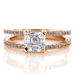 Simplistic elegance perfectly describes Design 2263. The classic design features a 1.00 carat asscher cut center diamond. The step cut facets of the asscher are perfectly contrasted with the double bands of round micro pavé diamonds. The diamond settings are individually hand cut by our jewelers. 