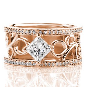 The kite-set 1.00 carat princess cut diamond draws the eye to the center of the design. Hand wrought platinum filigree curls add movement to contrast the straight lines of the square stone. Micro pavé line each side of this signature wide band for flashes of fire and sparkle.