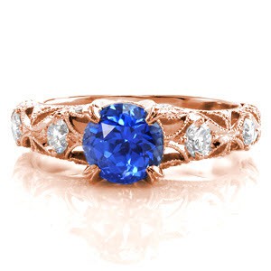 The pierced pattern has the perfect contrast of metal and open pockets. Every edge outlined with hand-formed milgrain detail lends to a gorgeous finish. Adorned with diamonds for a glittering affect, the vivid blue of the round sapphire is center of attention in this vintage inspired design.