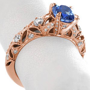 Columbus engagement ring with blue sapphire center stone and ornate diamond band.