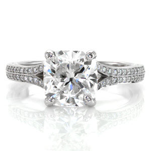 Custom engagement ring in Albany with a bead set diamond split band and a cushion cut center diamond.