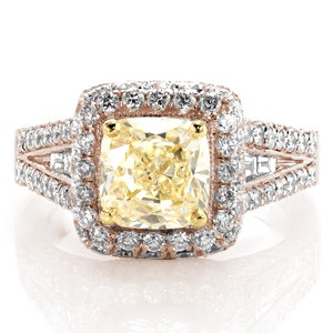 A magnificent halo design enveloped with micro pavé, this ring glimmers and shines from every angle. The center is a 1.50 carat fancy yellow cushion cut diamond set with an accent of yellow gold prongs. Channel set baguettes rest in the middle of the micro pavé. The design is framed with milgrain edges.