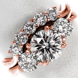 The Contour Trellis Matching Band makes a perfect fit next to the paired engagement ring. With five round cut diamonds totaling 0.30 carats, the gentle curve shadows the contour of the elegant three stone engagement ring. Crafted in 14k white gold, the interwoven prongs create an elegant profile.