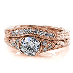 Details of round cut diamonds, hand engraved scrolls and filigree curls create this heirloom. The Seville Diamond Matching Band is hand crafted in 14k white gold and designed to wear next to the Seville engagement ring. The wedding band slightly contours to follow the shape of the engagement ring for a perfect fit. 