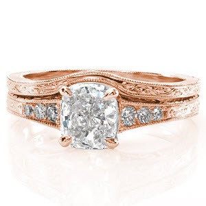 The Barcelona Matching Band is an exact fit to our Barcelona engagement ring. The band is designed with a soft curve to shadow the outline of the accompanying engagement ring. Crafted in 14k white gold, the band is adorned with hand engraved scrolls and wheat engraving on the two outside surfaces of the ring. 