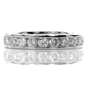 Vita 1.2 is a timeless statement that will compliment the style of almost any engagement ring. Large round brilliant diamonds are channel set along the length of the high polished edges adding brilliance to the center of the band. These vibrant stones are dazzling and create a luxurious statement.