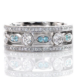 The Dolce featuring round cut blue diamonds is a sophisticated and updated look on an heirloom band. Crafted in 14k white gold, two outside rails of micro pavé diamonds frame an alternating round and marquis configuration. A single row of milgrain creates an adorned ring edge.