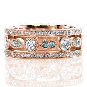 The Dolce featuring round cut blue diamonds is a sophisticated and updated look on an heirloom band. Crafted in 14k white gold, two outside rails of micro pavé diamonds frame an alternating round and marquis configuration. A single row of milgrain creates an adorned ring edge.