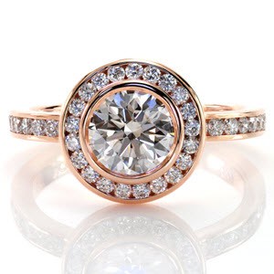 Custom created classic engagement ring with a bezel set round center diamond surrounded by a channel set diamond halo and diamond band in Las Vegas