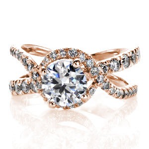 This unique halo design has woven rows of micro pavé diamonds cascading over and under the delicate split band design. The diamonds flow around and under the four prong 1.00 carat center stone, adding movement and radiance. The design is exclusively Knox, and sure to make a statement. 