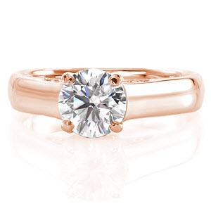 This design features a four prong 1.00 carat round brilliant cut diamond gracefully held in a cathedral style mounting. The shank is wider in style for a secure and contemporary feel. The side profile surprises with pockets of magnificent, hand formed filigree curls. 